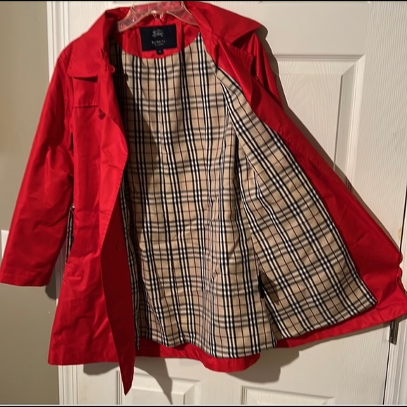 Burberry of London Red trench coat with belt.